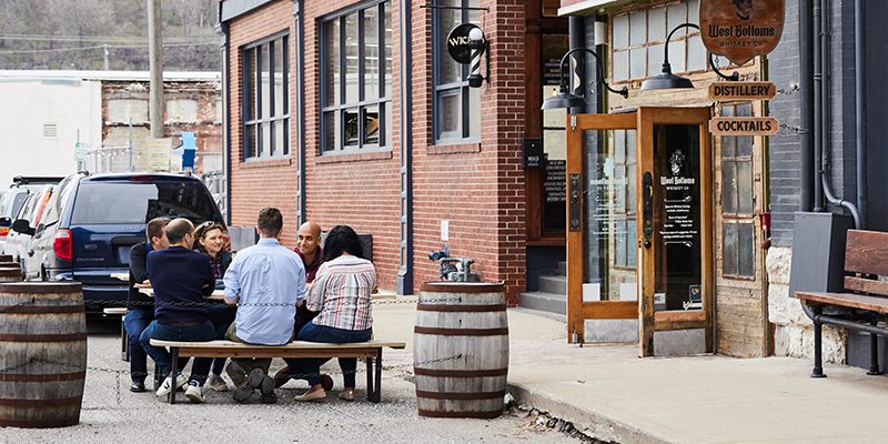 Group sitting outside West Bottoms Whiskey Co.